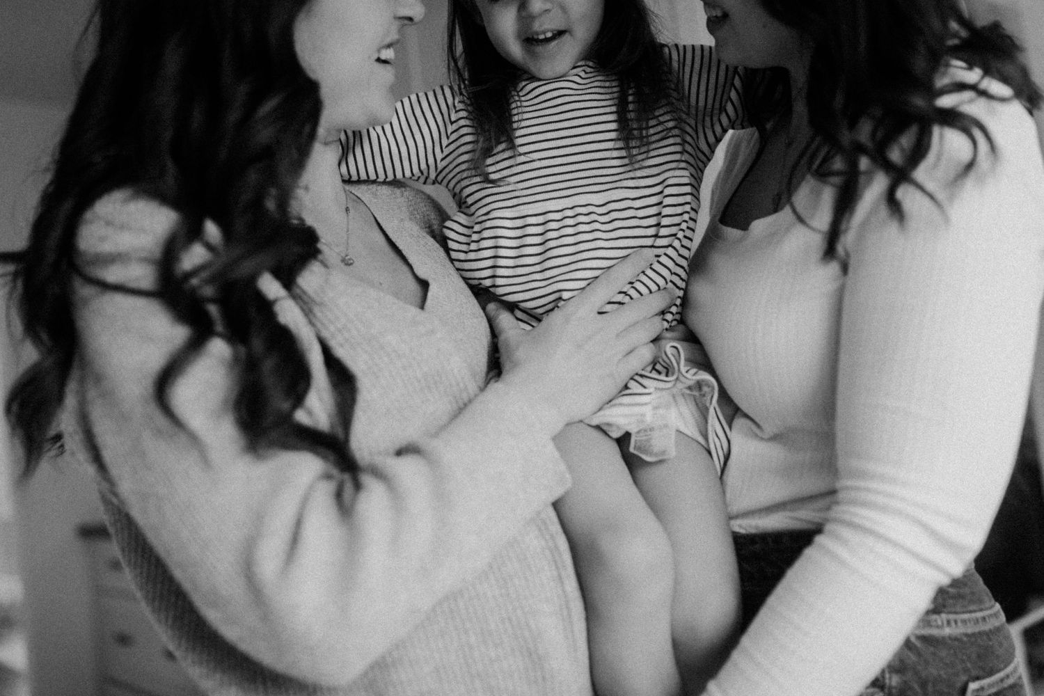 An intimate black and white photograph capturing a tender moment of shared joy and comfort.