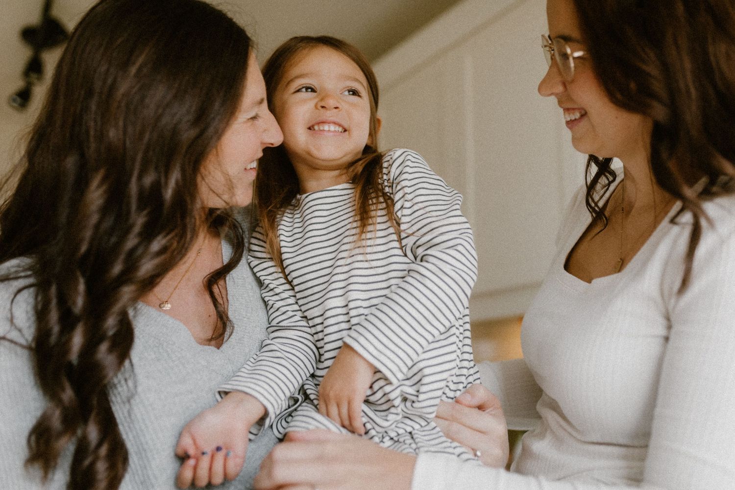Queer family share a candid moment of joy and connection.