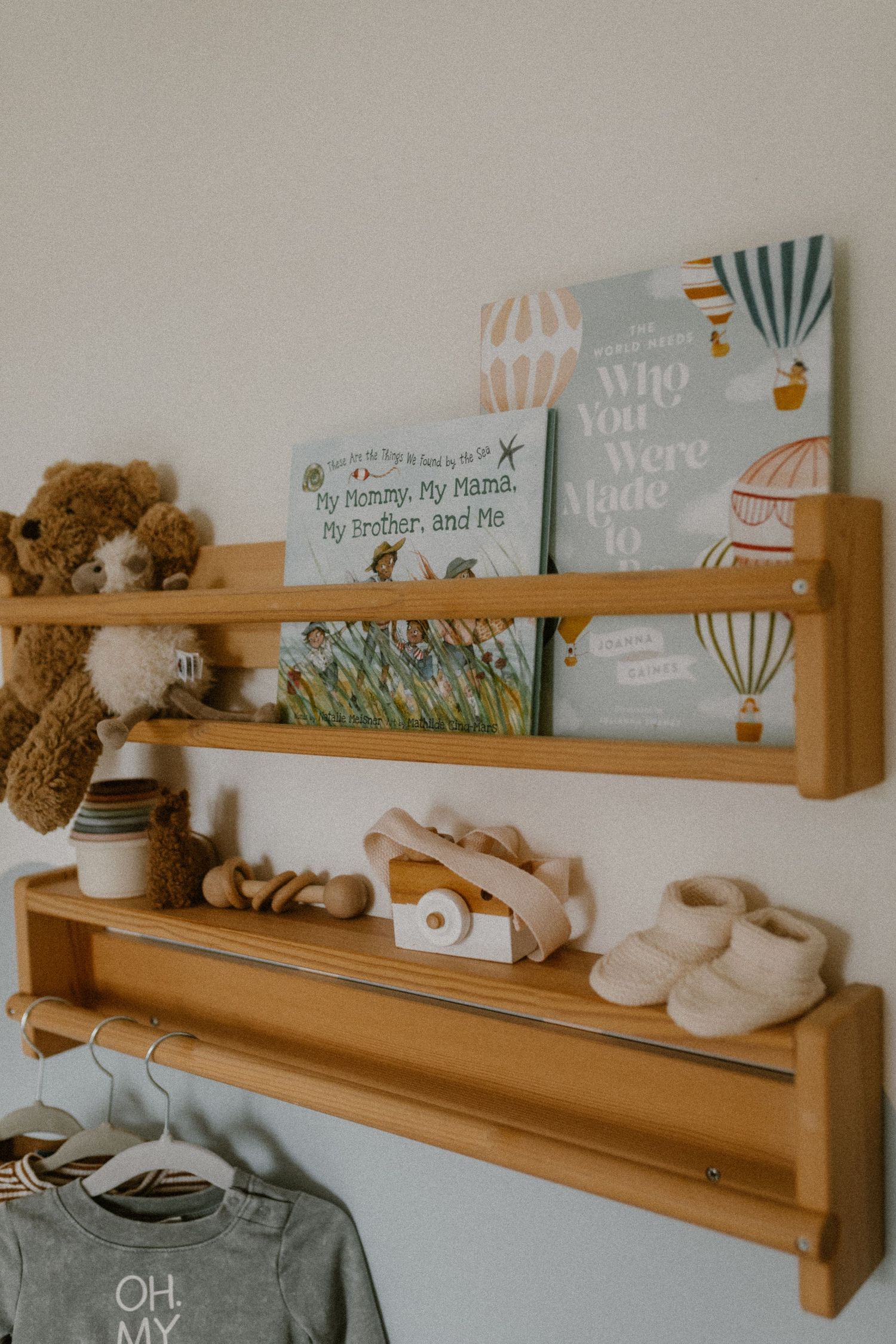 Nursery shelf with children's books, stuffed animals, and cute baby accessories.