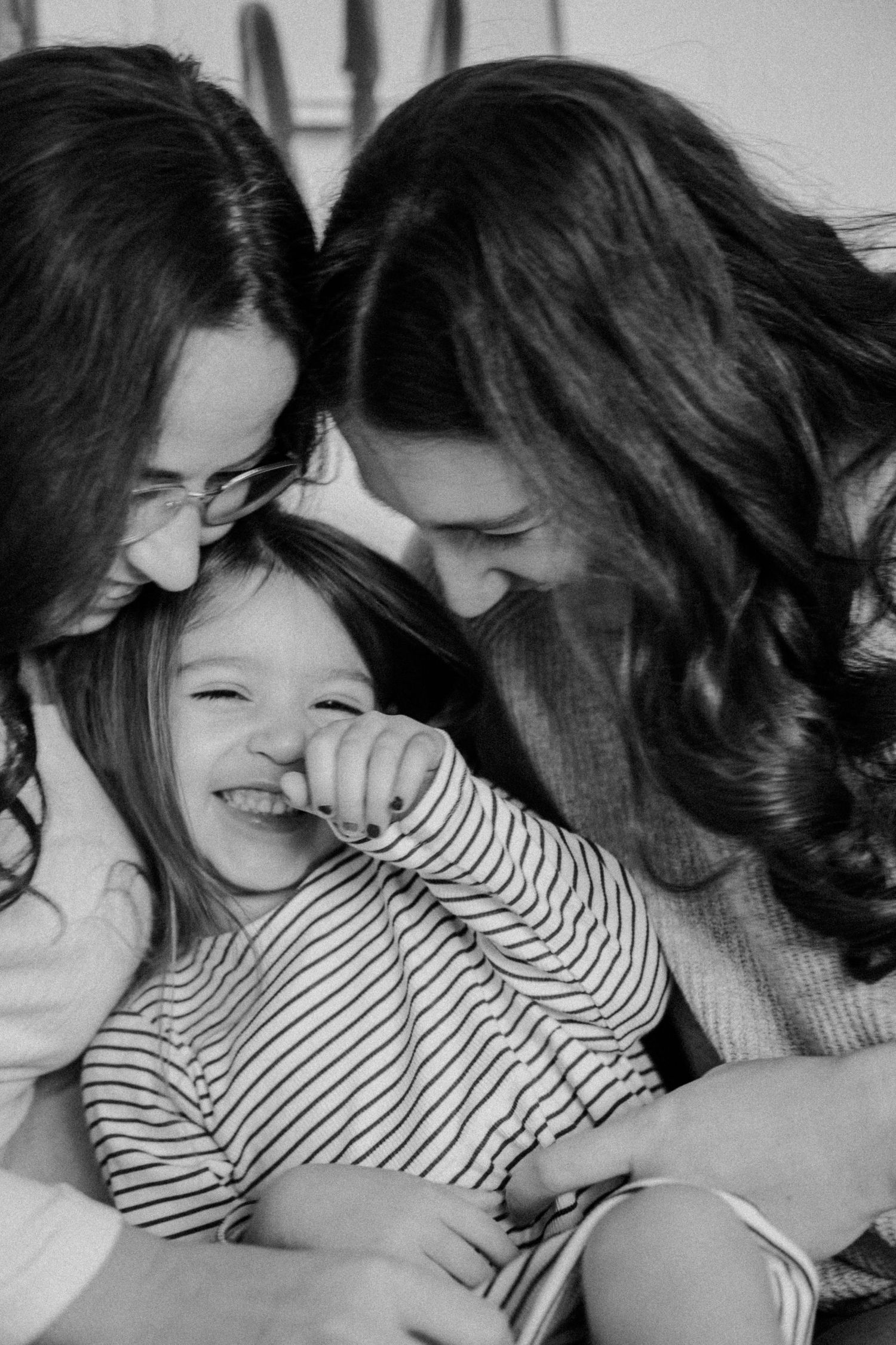 A joyful black and white portrait showing laughter and happiness.