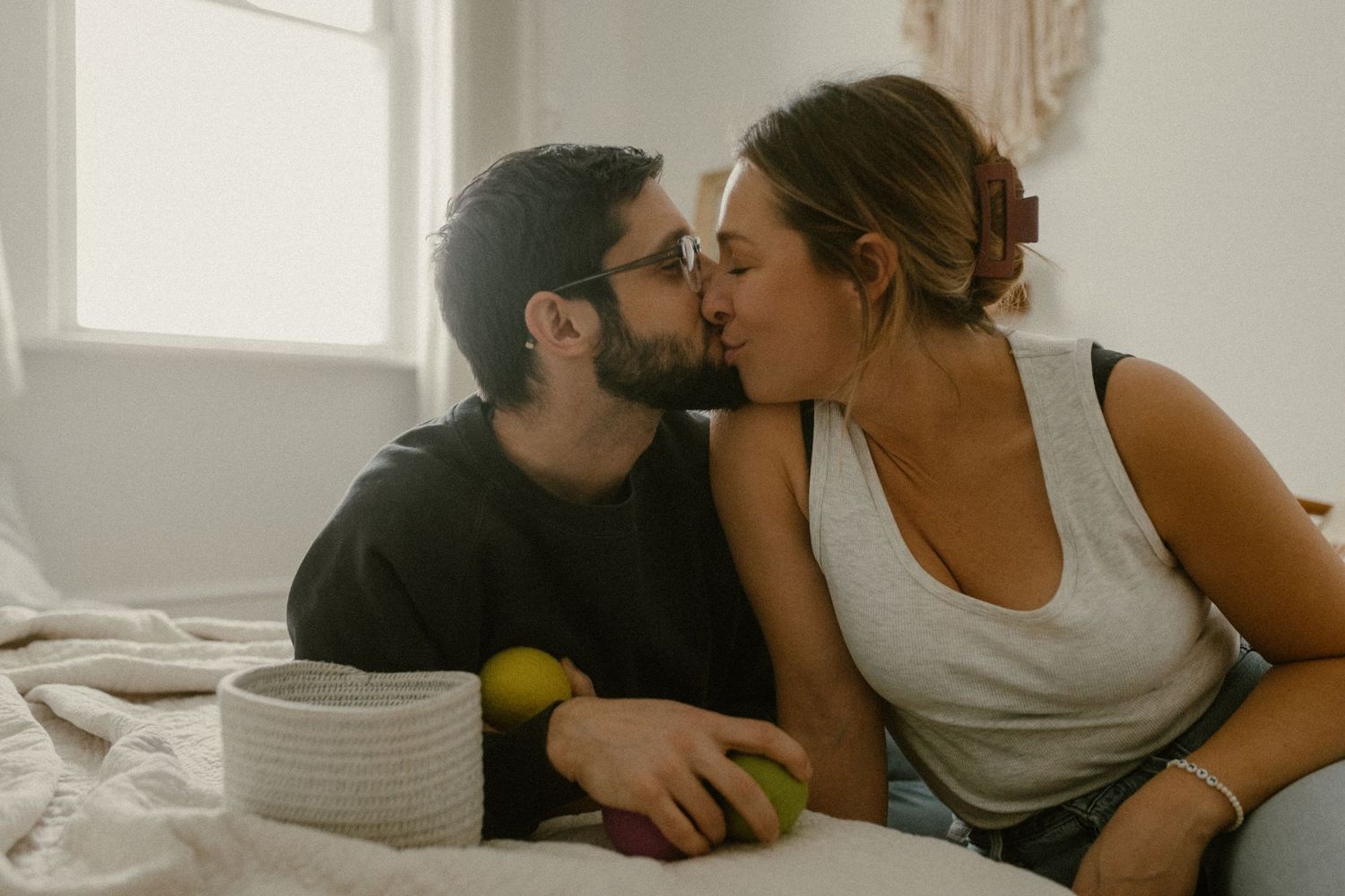 Intimate moment shared between couple during playful activity with colorful balls.