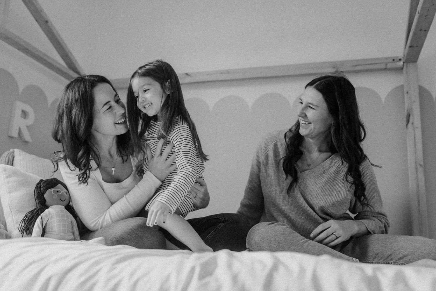 A heartwarming black and white moment of connection on a bed.