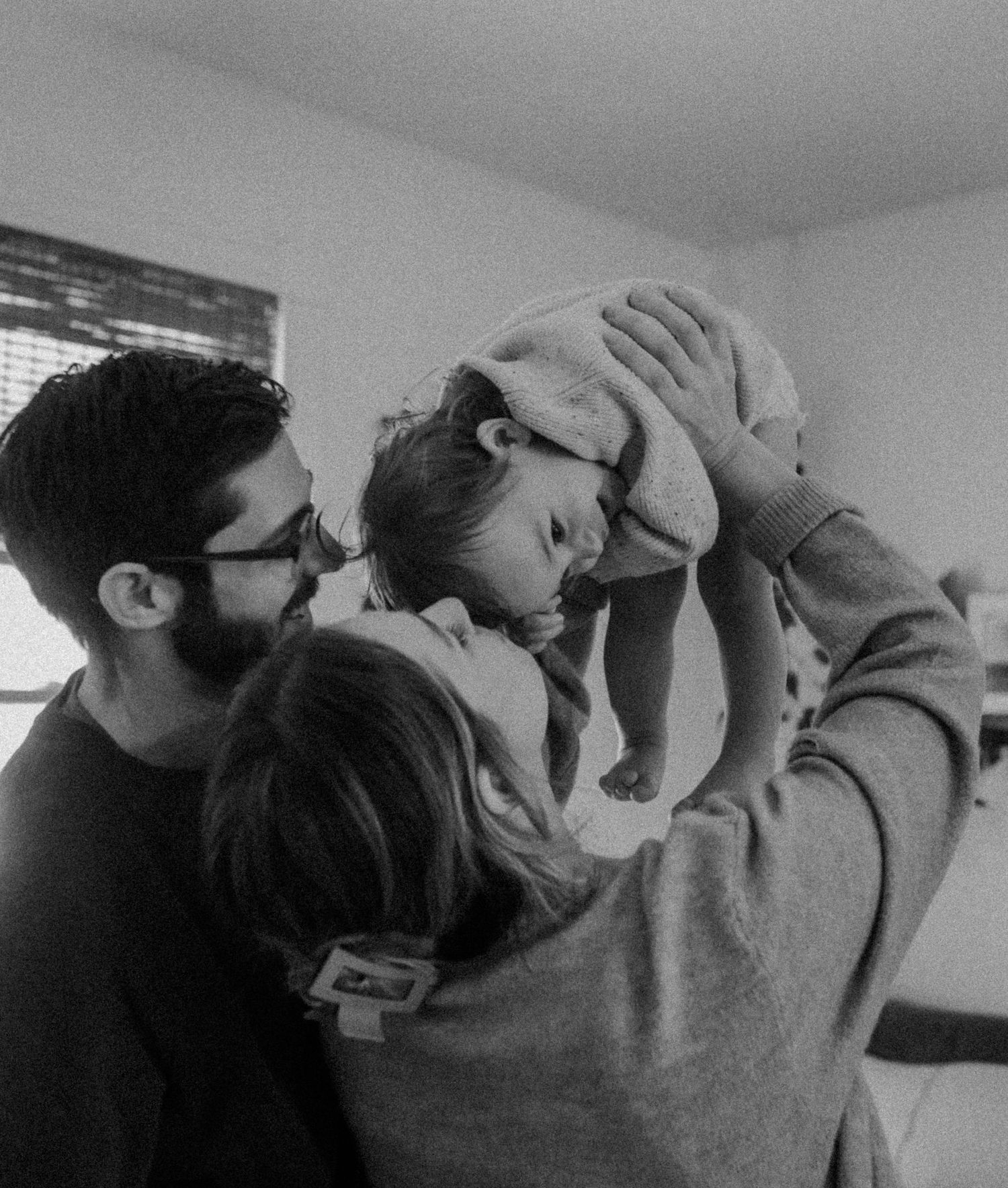 A tender family moment captured in black and white photography.