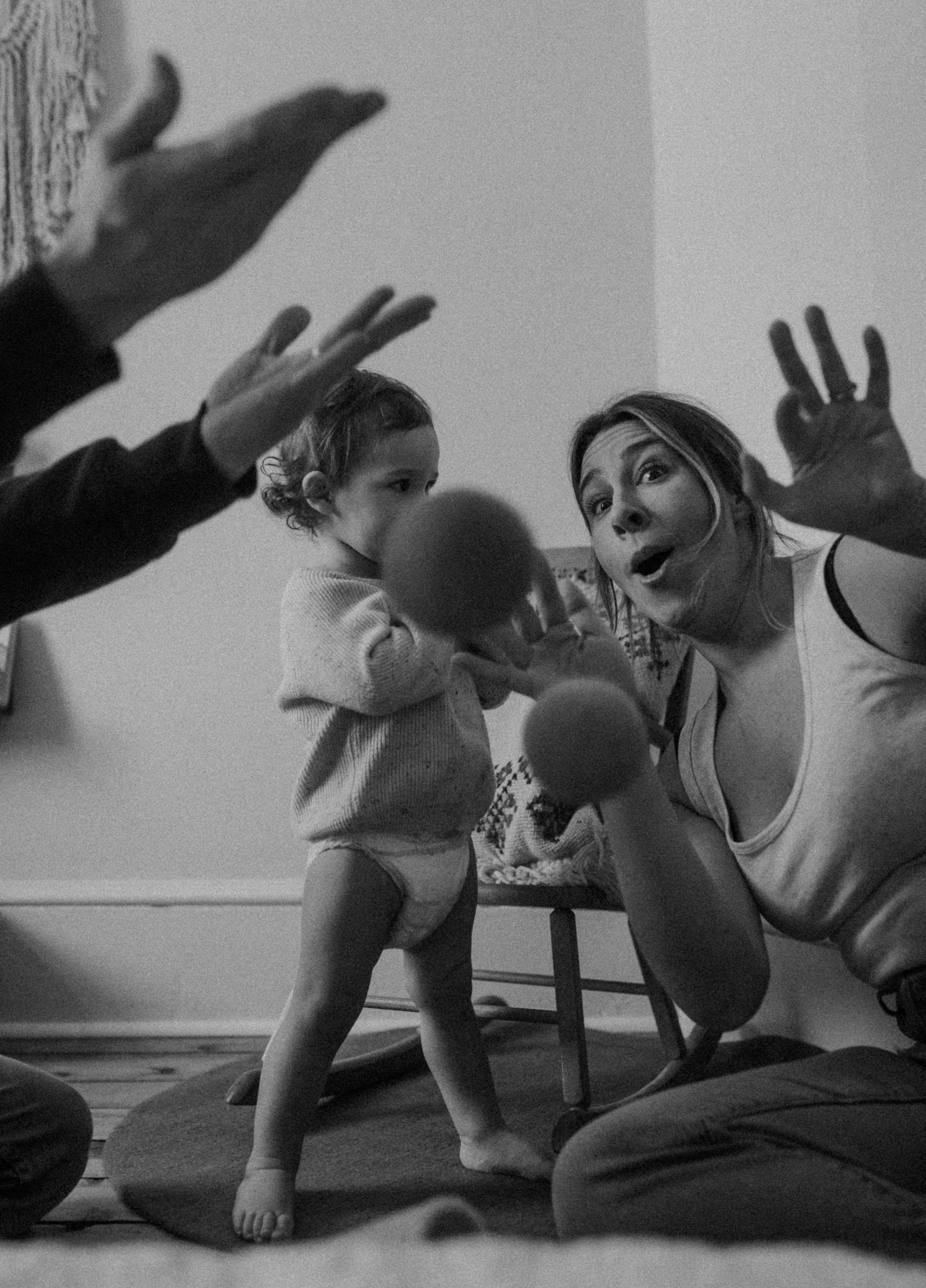 Playful moment with balls and shadows during indoor playtime on a comfortable bed.