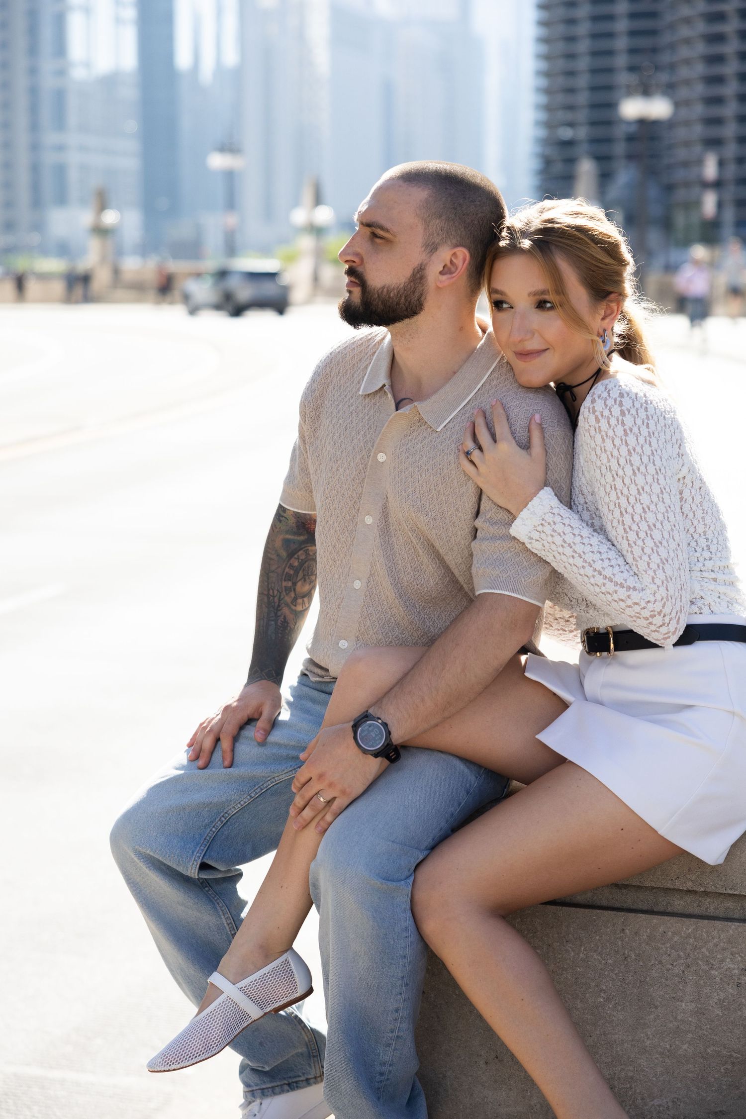 A couple sits together on a concrete ledge in an urban setting sharing romantic moments across multiple photos.