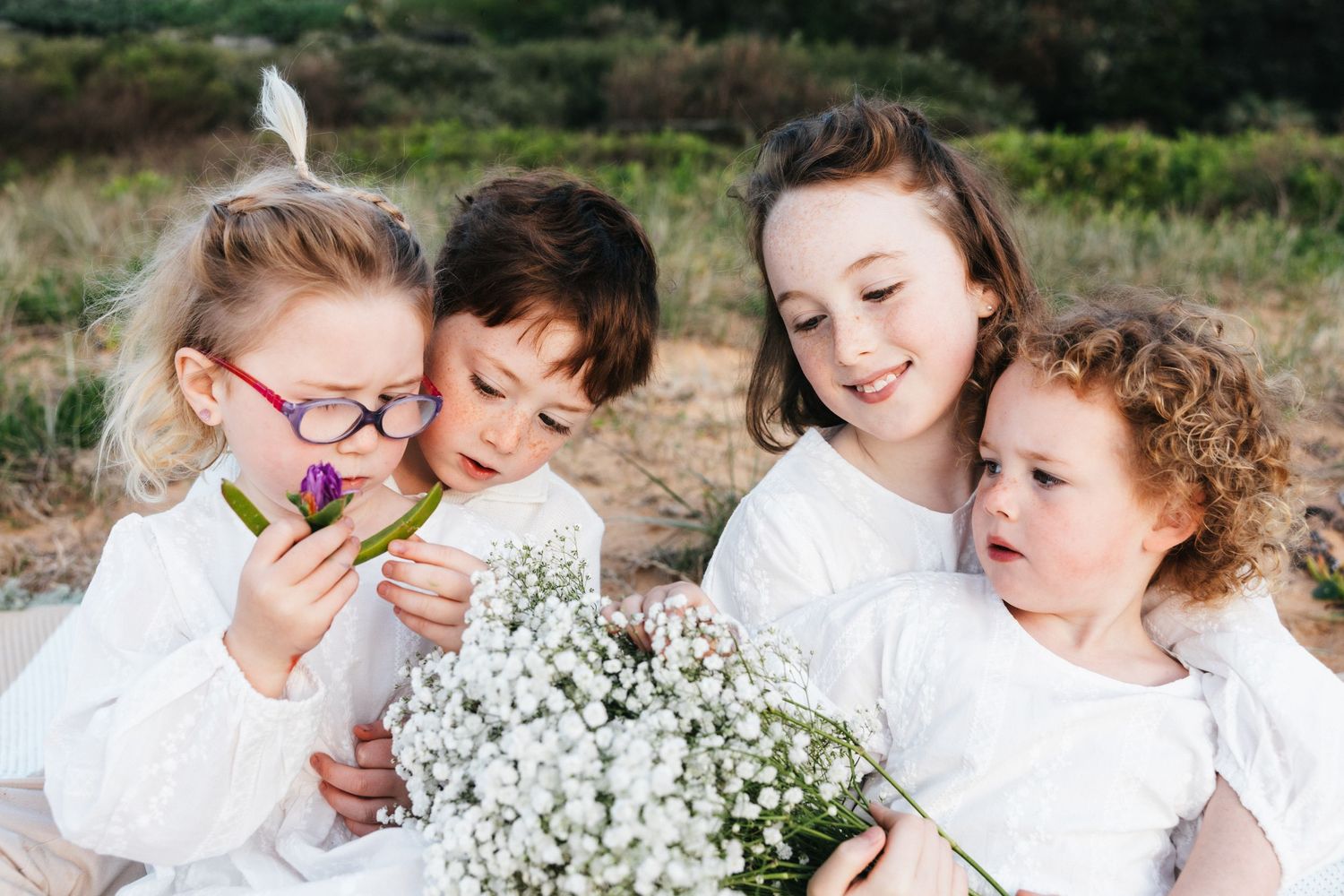 Family Photography - Candid picture of four siblings/kids on picnic blanket at Bilgola Beach, Northern Beaches, Sydney
