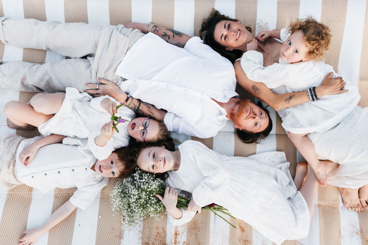 Family Photography - Happy big Family  lying on picnic blanket at Bilgola Beach, Northern Beaches, Sydney
