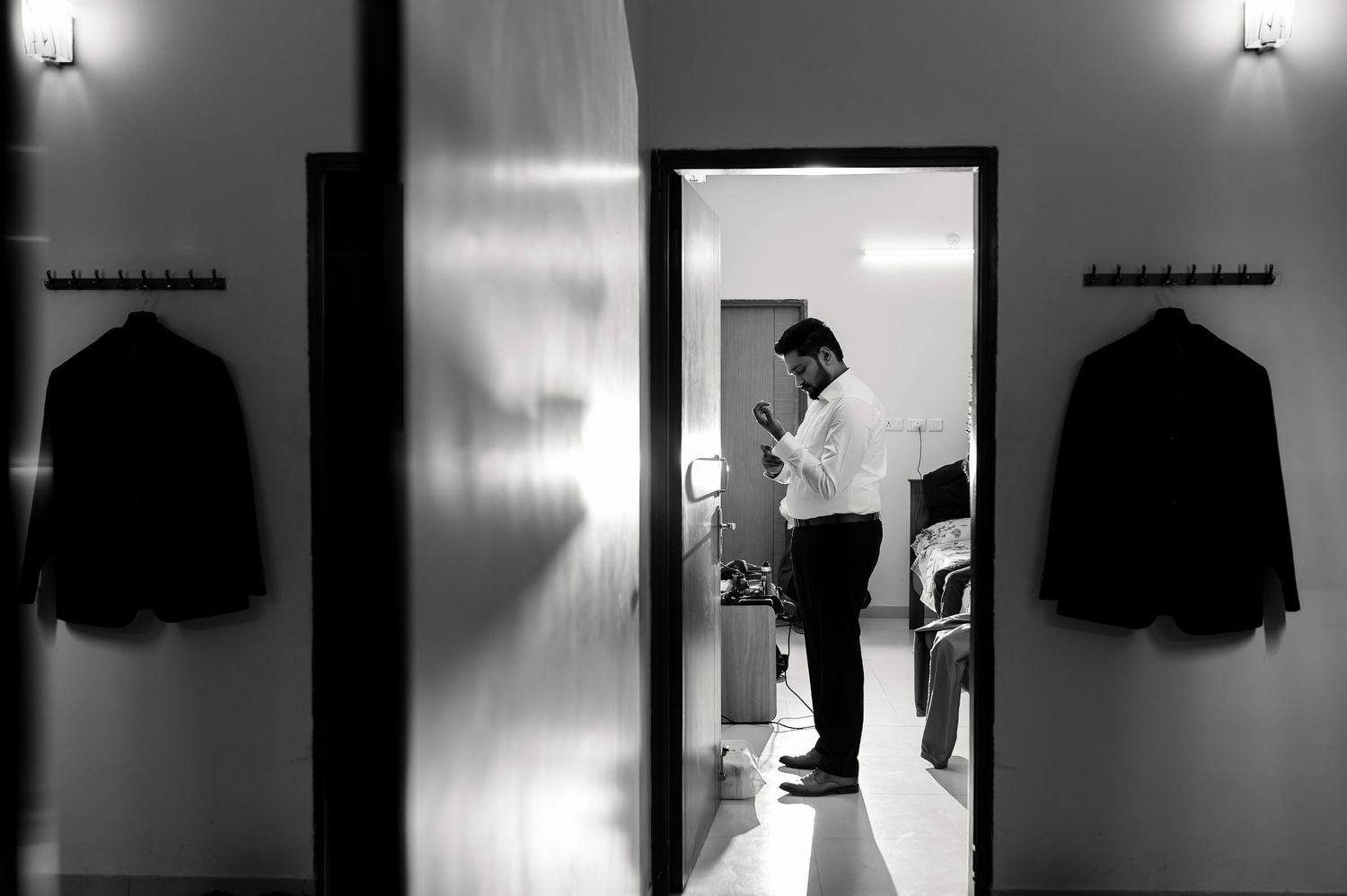 Bride preparing quietly for her wedding ceremony in a softly lit room.