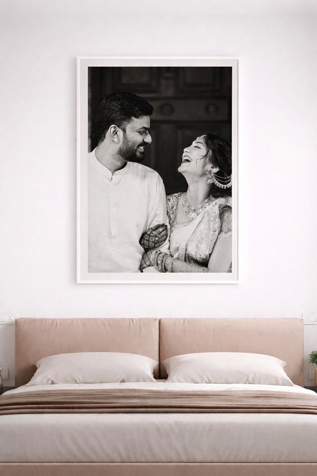 A series of minimalist bedroom photos showing a white bed with pink walls and a black and white photograph above.