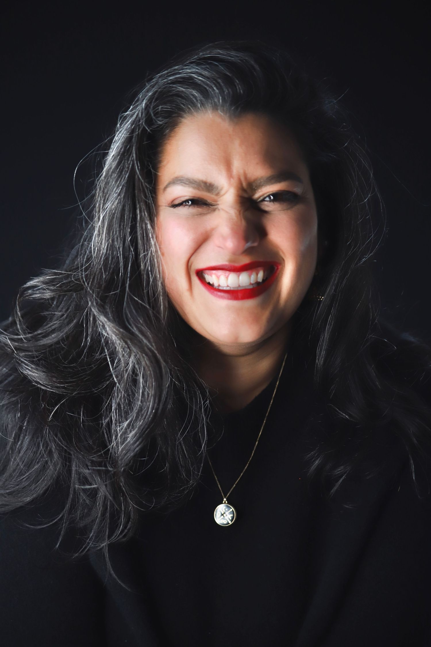 Artistic portrait series showing bright red lipstick and dark hair against black background.