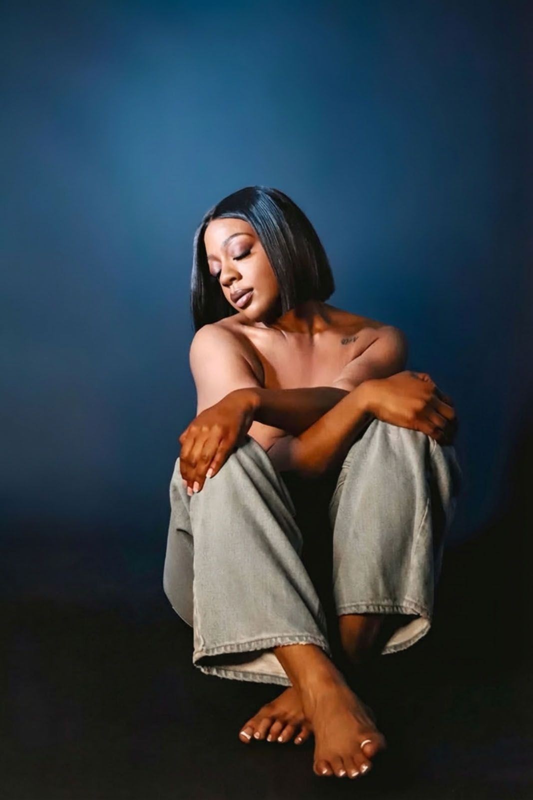 A moody artistic photo series showing bare feet and knees wrapped in gray fabric against a dark blue background.