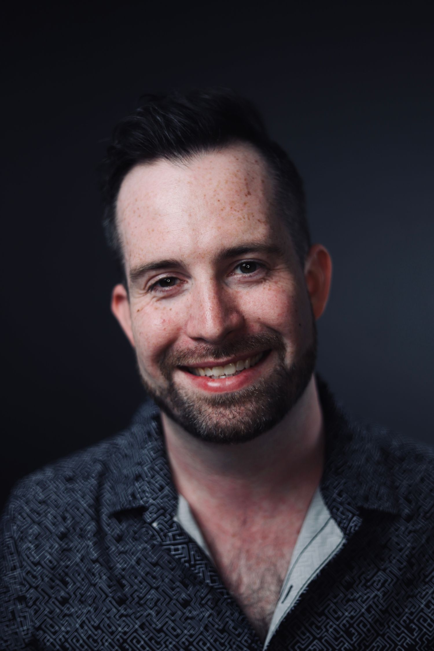 Warm portrait series showing genuine smiles in textured sweater.