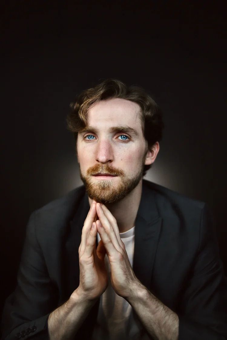 Moody portrait series featuring dramatic lighting on person with beard in dark setting.