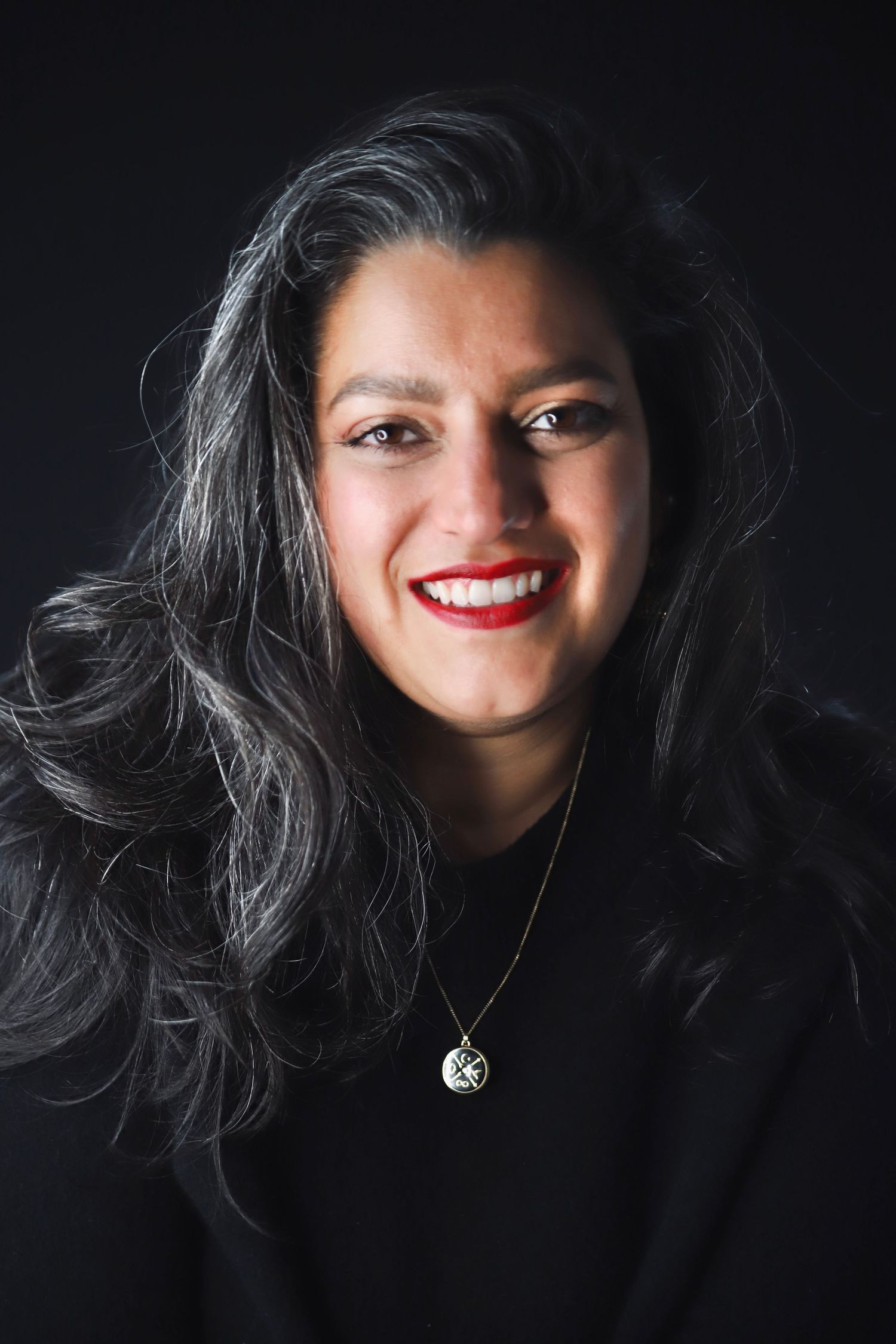 Dramatic portrait series featuring bright red lipstick against dark background with flowing black hair.