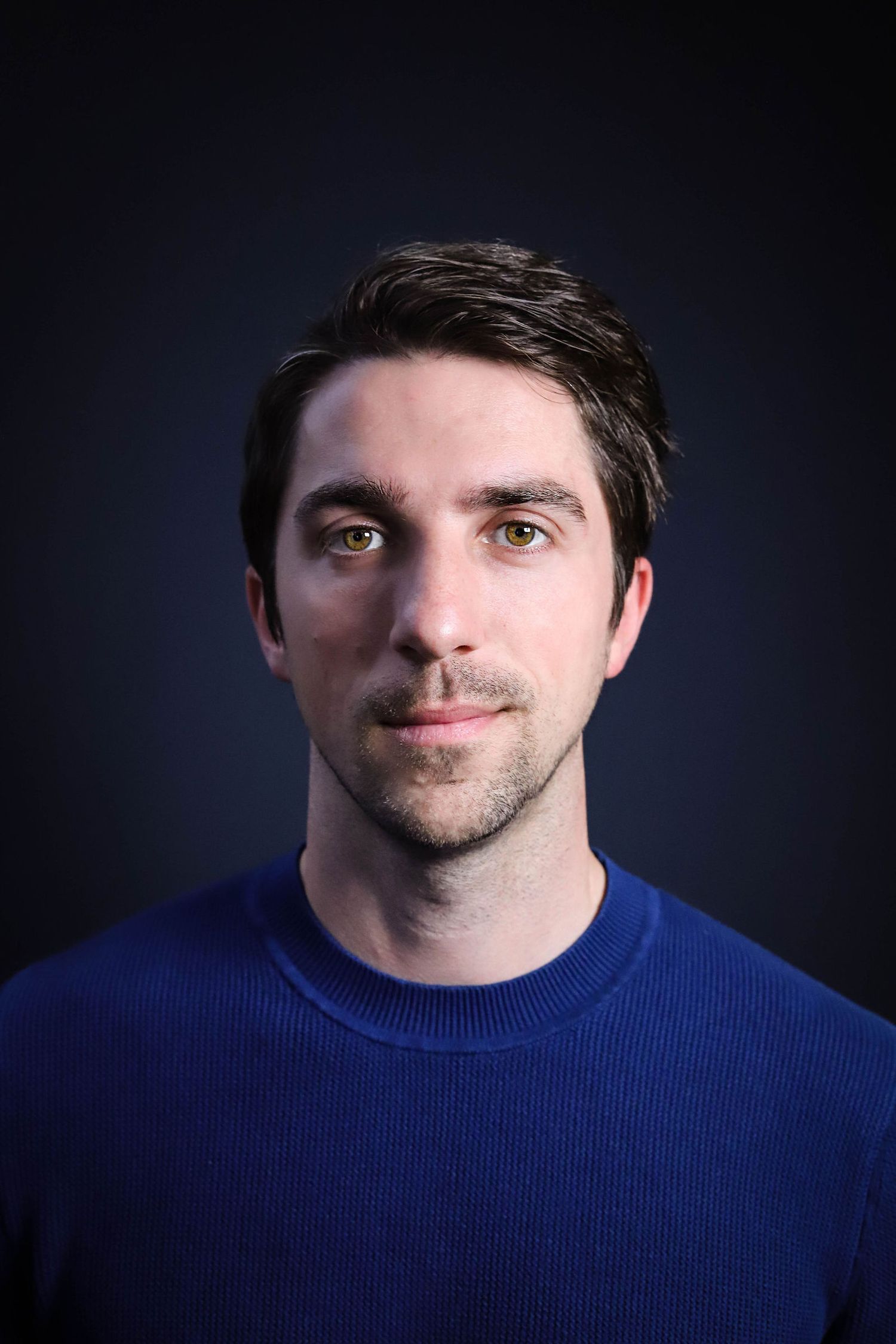 Portrait series showing a person in a blue sweater against dark background from different angles.