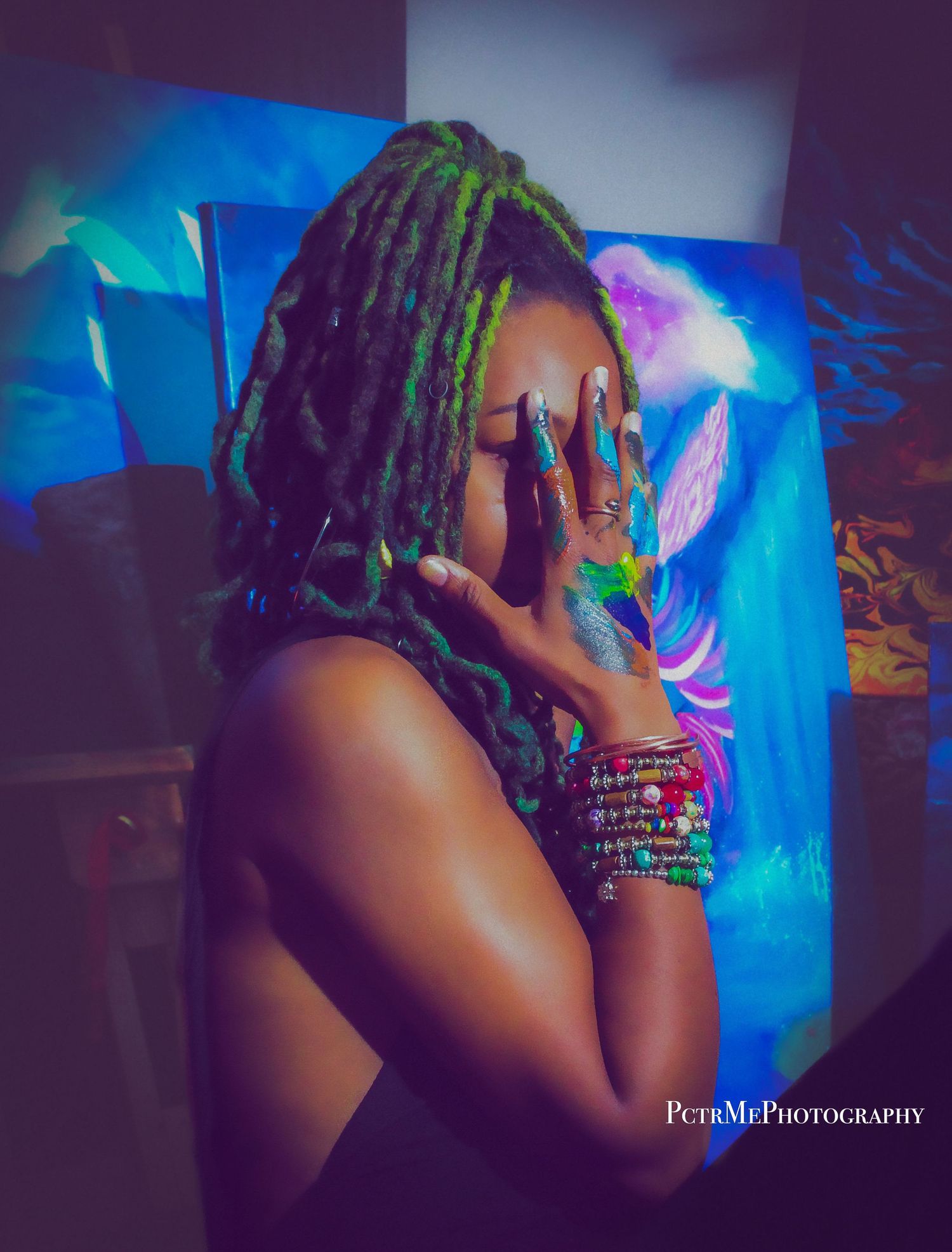 Creative portrait of an artist posing in front of a colorful painted backdrop, capturing self-expression and creativity