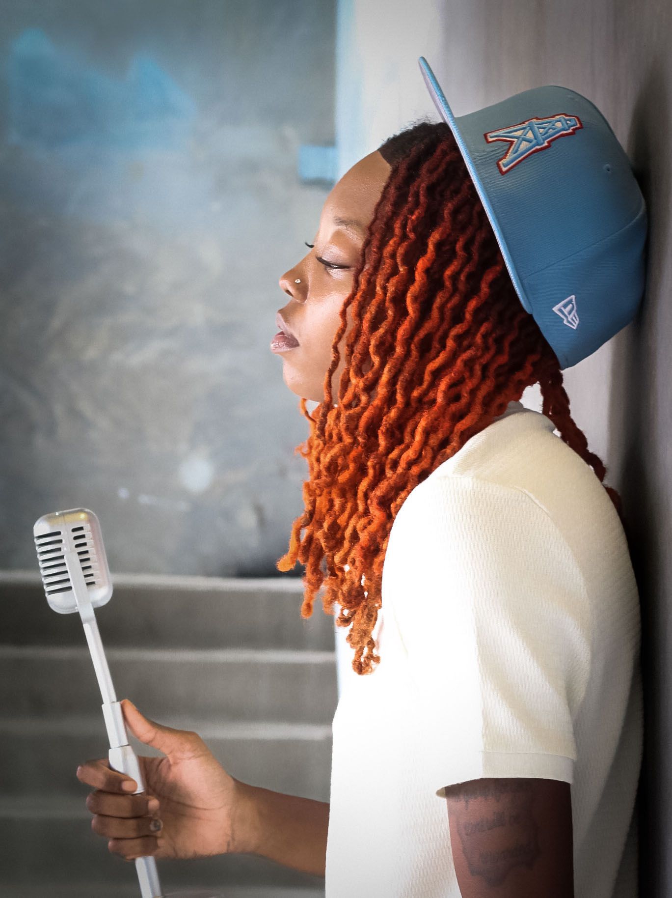 Creative branding portrait of an artist holding a microphone, capturing individuality, expression, and style