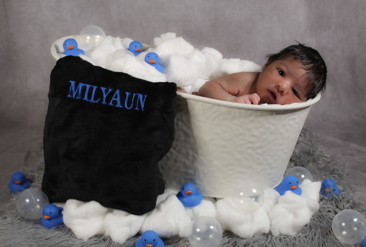 Newborn baby resting peacefully in a styled portrait setup celebrating a beautiful birth milestone