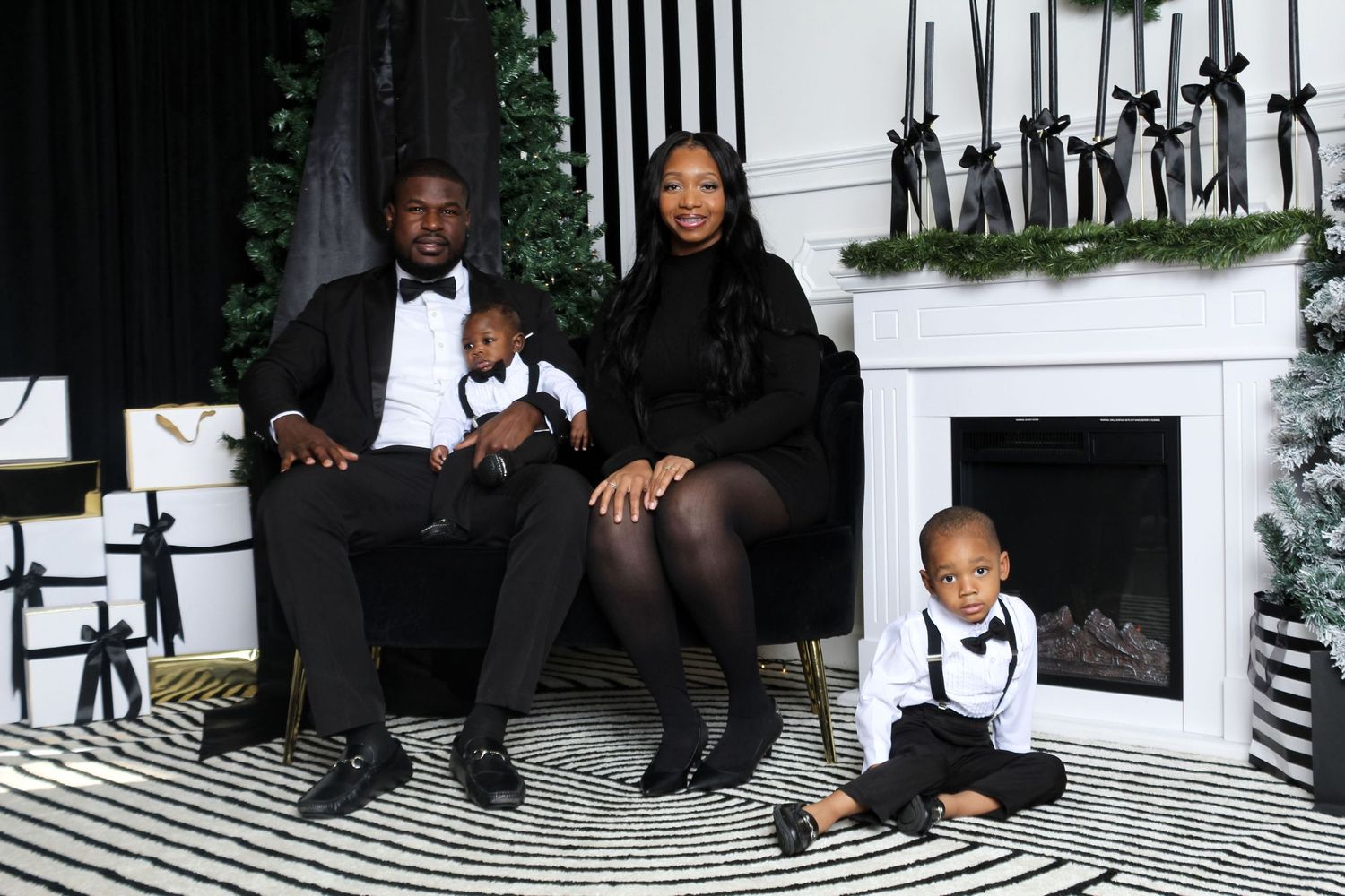 Family portrait of parents and children seated together in a holiday studio setting, capturing togetherness and connection