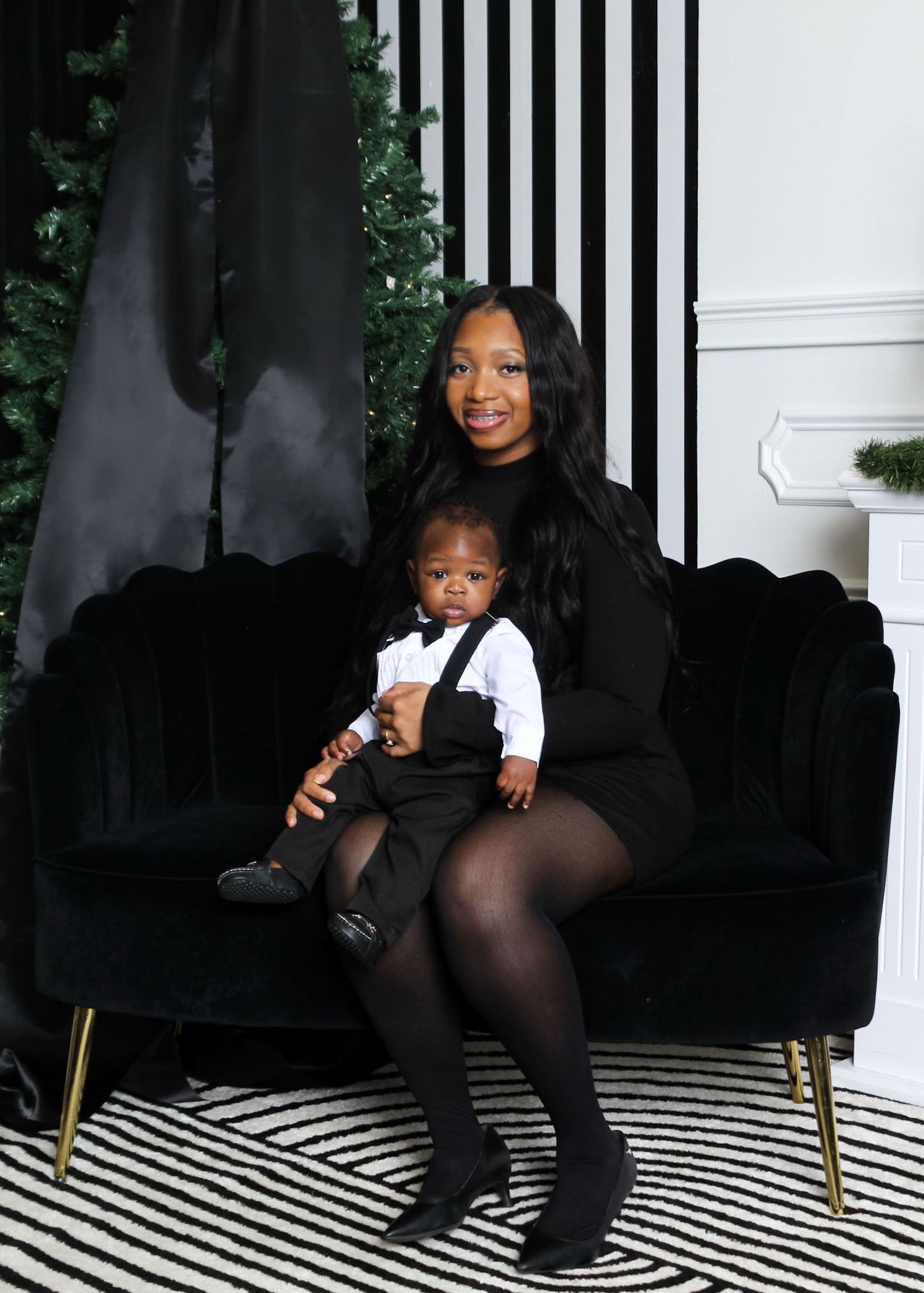 Mother seated with her child during a studio family portrait session, capturing warmth, love, and closeness