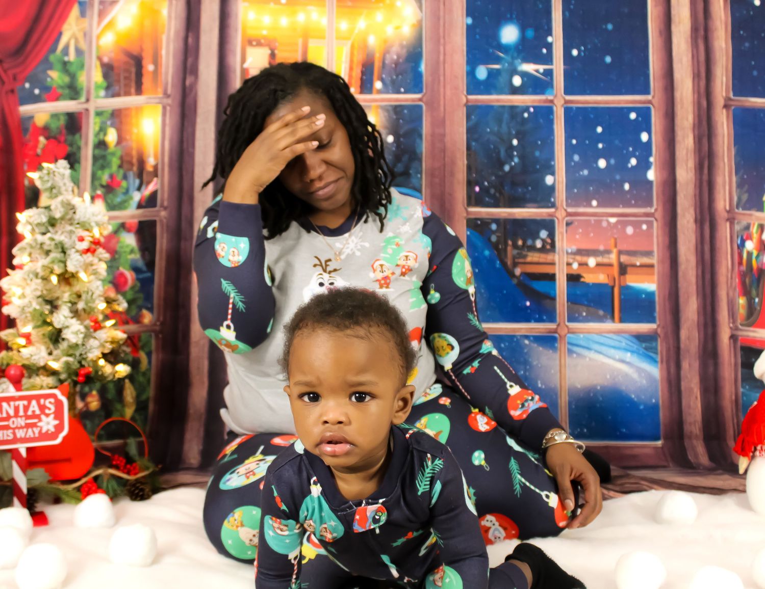 Mother and children sitting together in matching pajamas during a holiday family portrait session