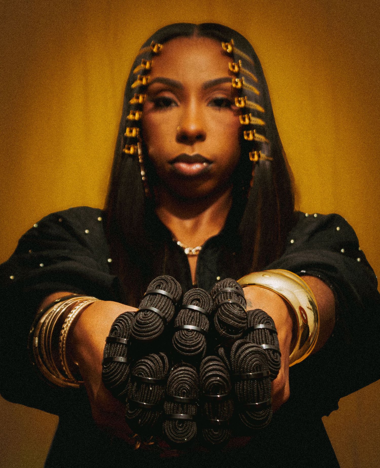 A sequence of images showing hands holding bundles of dark coiled hair extensions against a warm golden background.