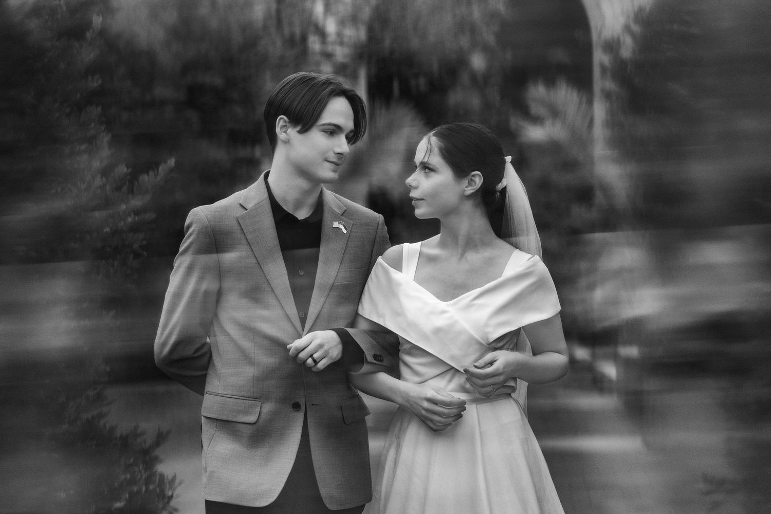 Black and white romantic couple portrait in a natural outdoor setting.