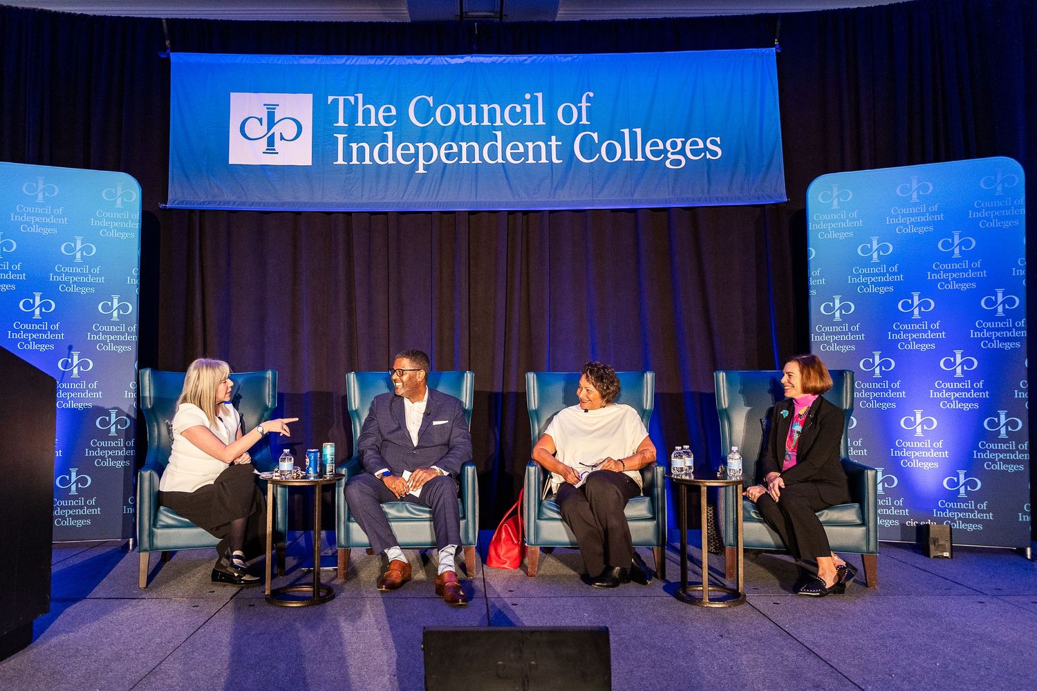 Panel discussion event at a Council of Independent Colleges conference with speakers on stage.