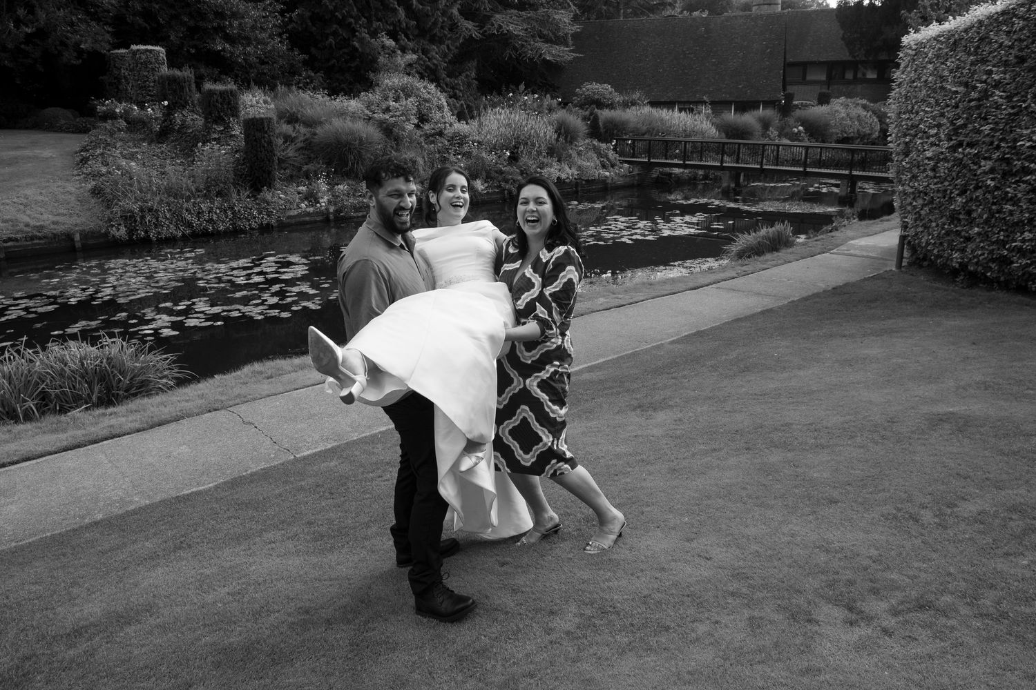 Playful wedding photo sequence showing movement and laughter in black and white.
