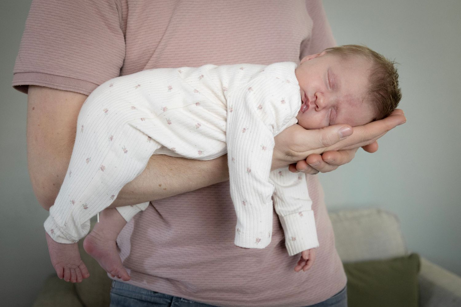 Father cradling a newborn baby.