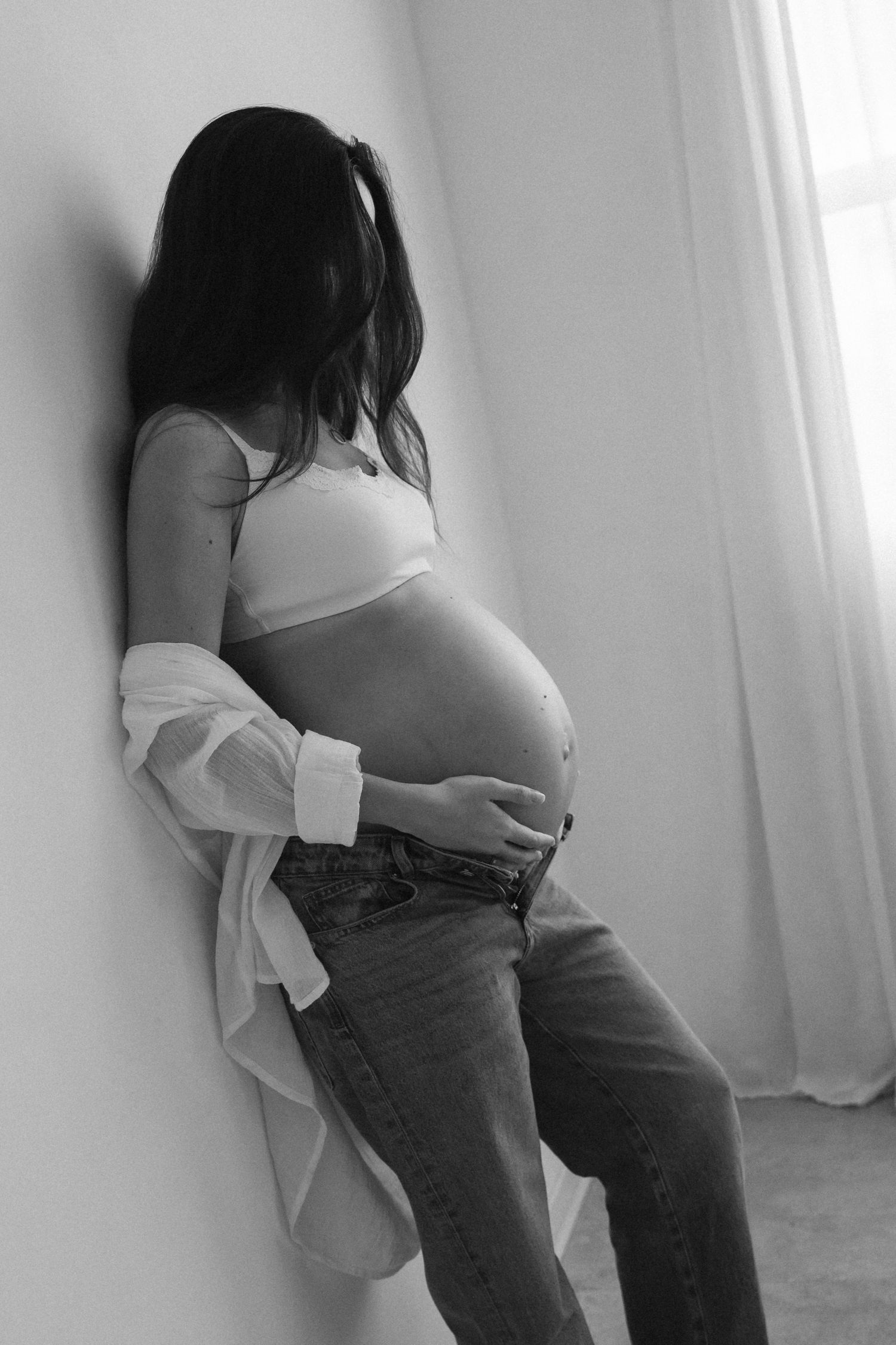 Black and white maternity progression photos showing pregnancy journey.