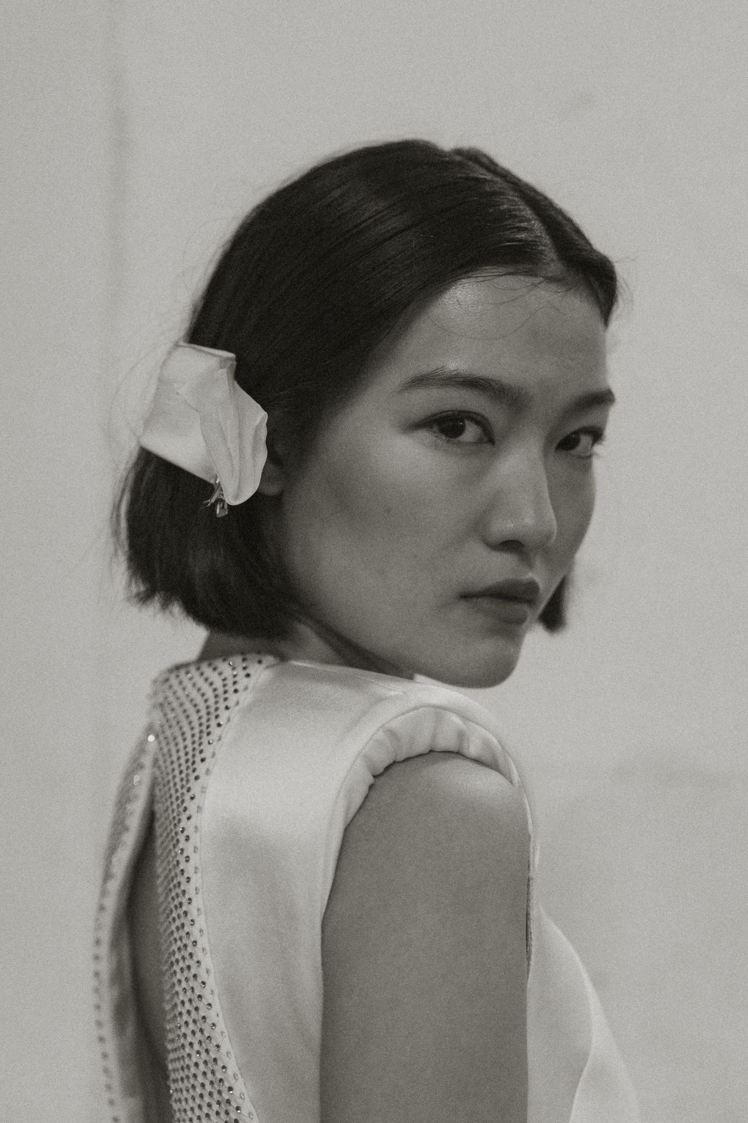 Minimalist black and white portrait showcasing delicate lace details and dramatic side profile.