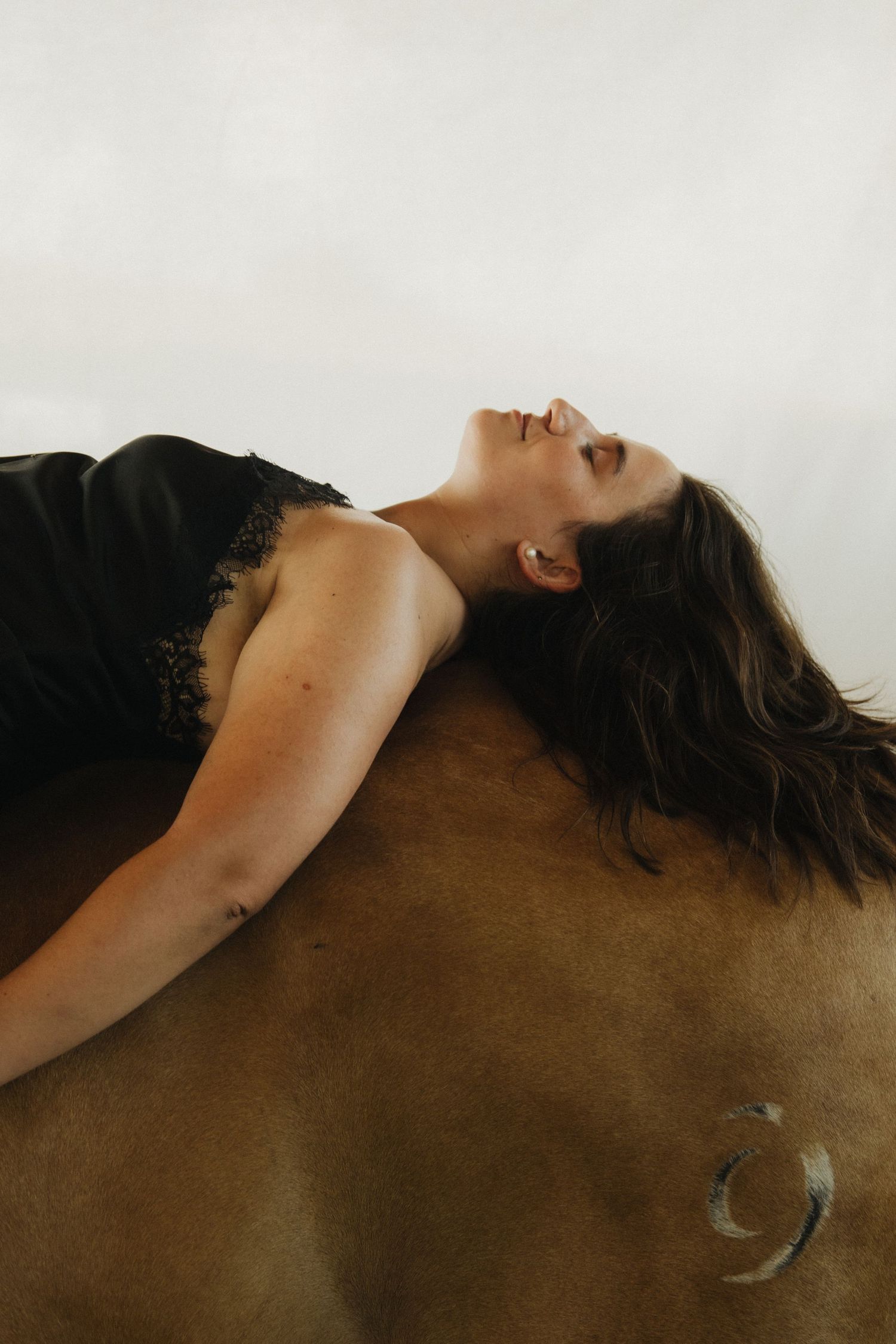 Artistic portrait series showing reclining figure against dark background.