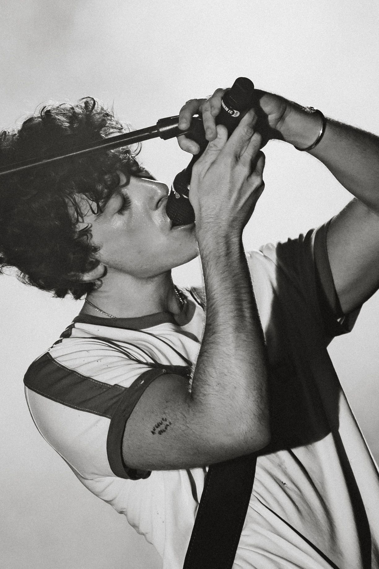 Black and white photo sequence showing someone drinking from a bottle in profile view.