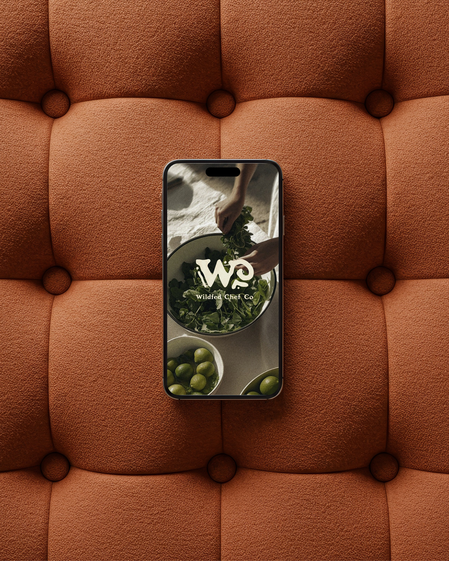 A smartphone displaying the Willow & Oak Co. logo rests on a tufted brown leather surface.