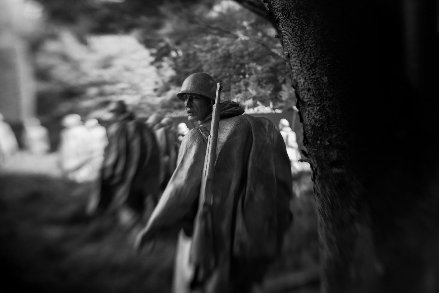 Black and white photo of Korean War Veterans Memorial statues of soldiers on patrol in Washington DC.