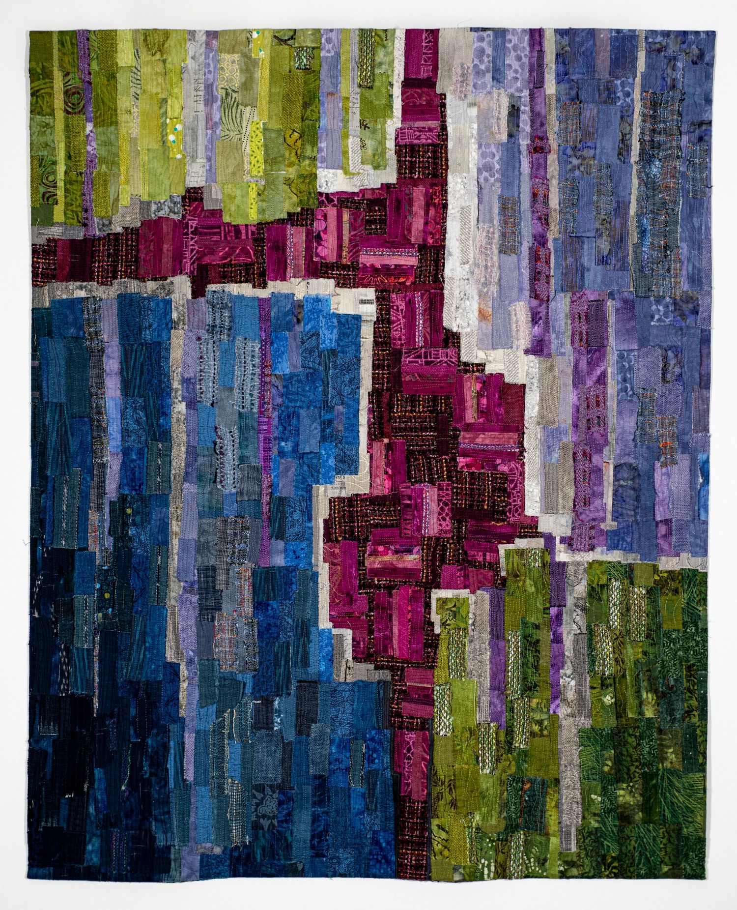 Abstract digital artwork featuring vertical stripes in blue, magenta, and green colors creating a pixelated gradient effect.
