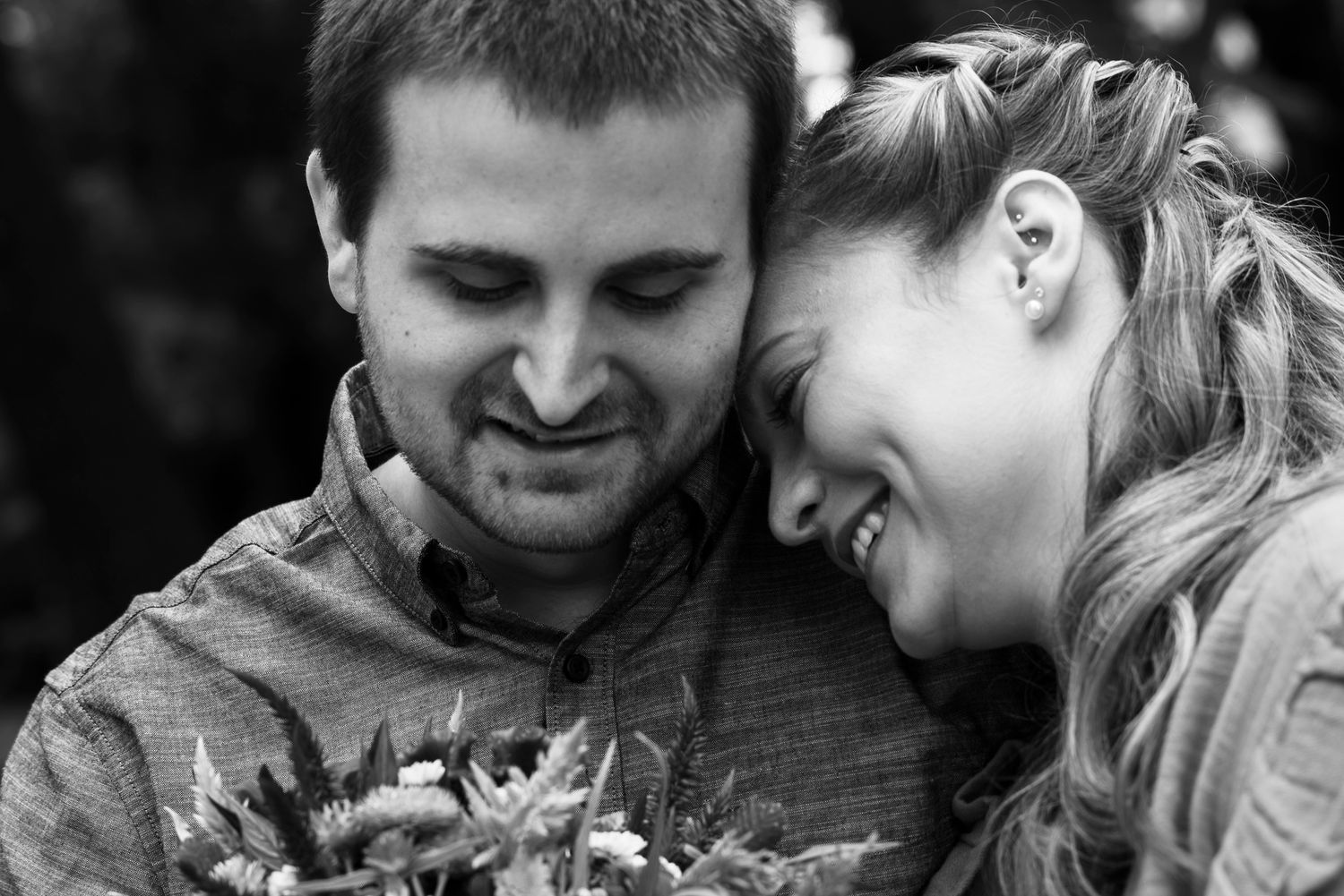 Intimate black and white portrait showing couple in romantic pose.