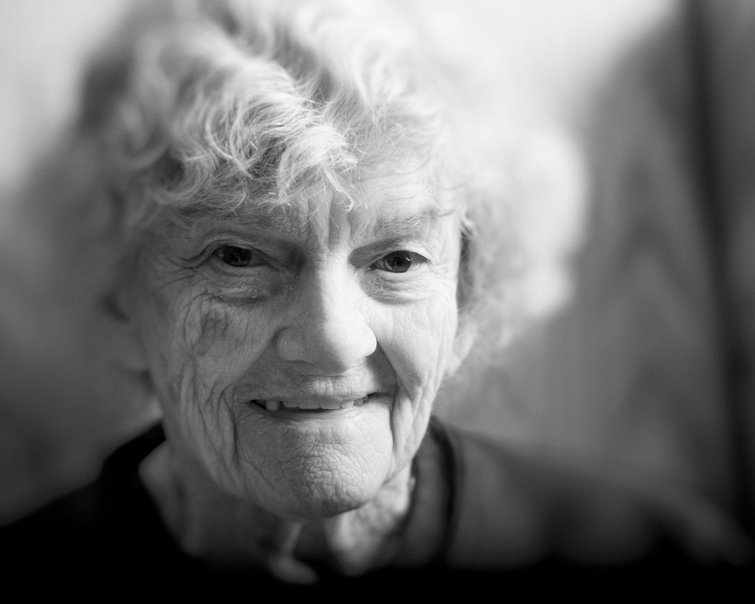 Artistic black and white portrait with soft focus and dramatic lighting.