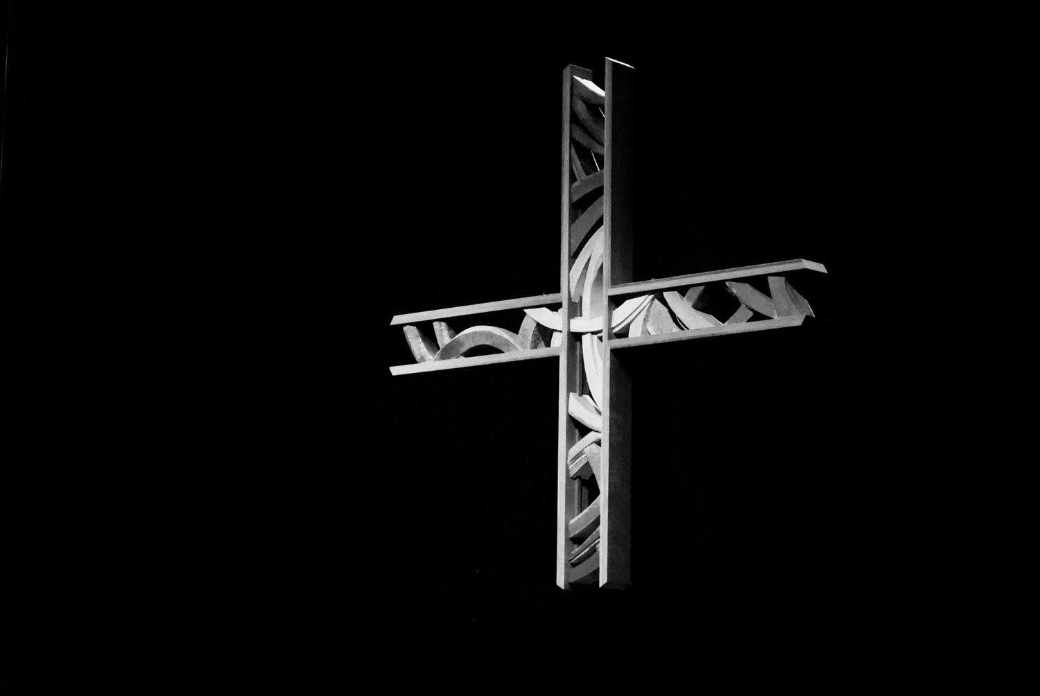Black and white image of illuminated modern cross against black background Good Shepherd Episcopal Church MD
