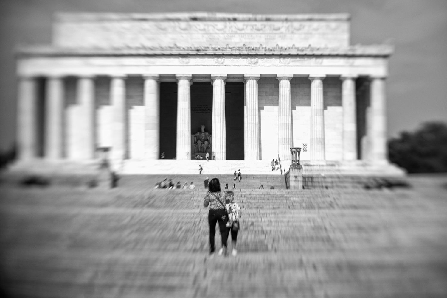 Wide panoramic view of a steps leading to Lincoln Memorial with people on the stairs