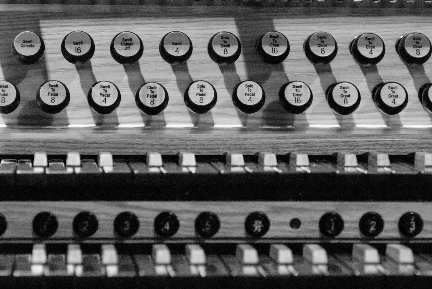 Detail of organ console at Christ Church Kensington showing stops and keys in black and white