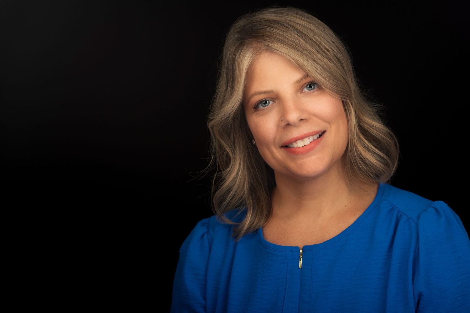 headshots showing a woman in a royal blue top against black background.