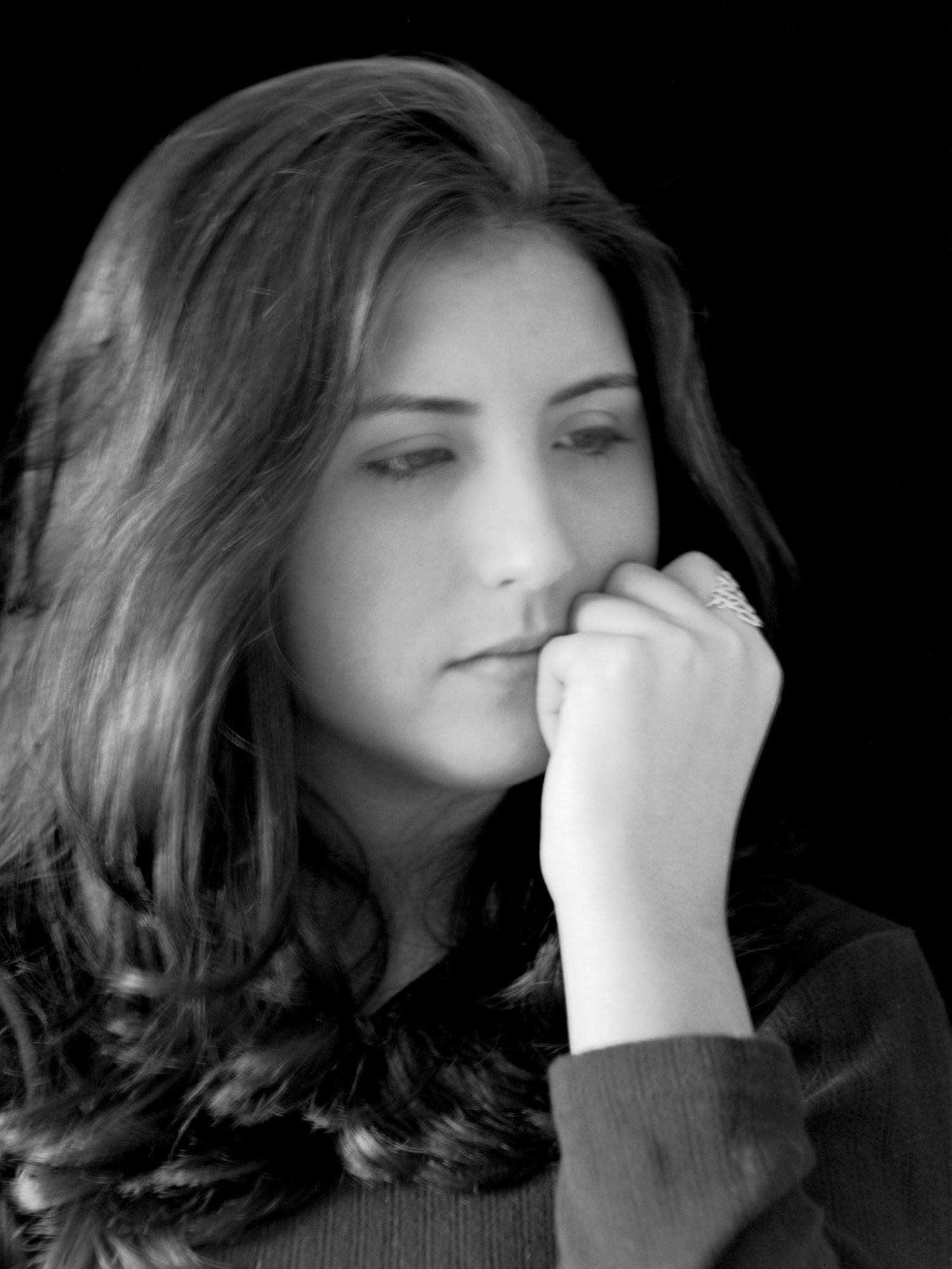 A series of black and white portraits showing someone holding their hand over their nose in various poses.