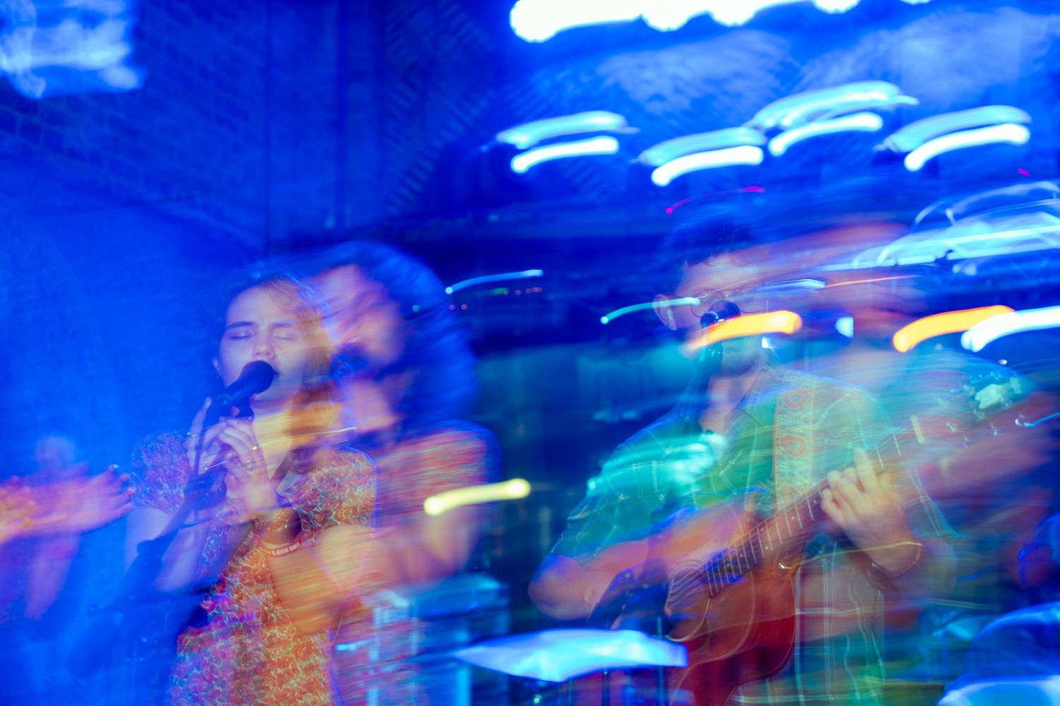 Abstract blue light trails and motion blur creating dynamic patterns in nighttime photography.