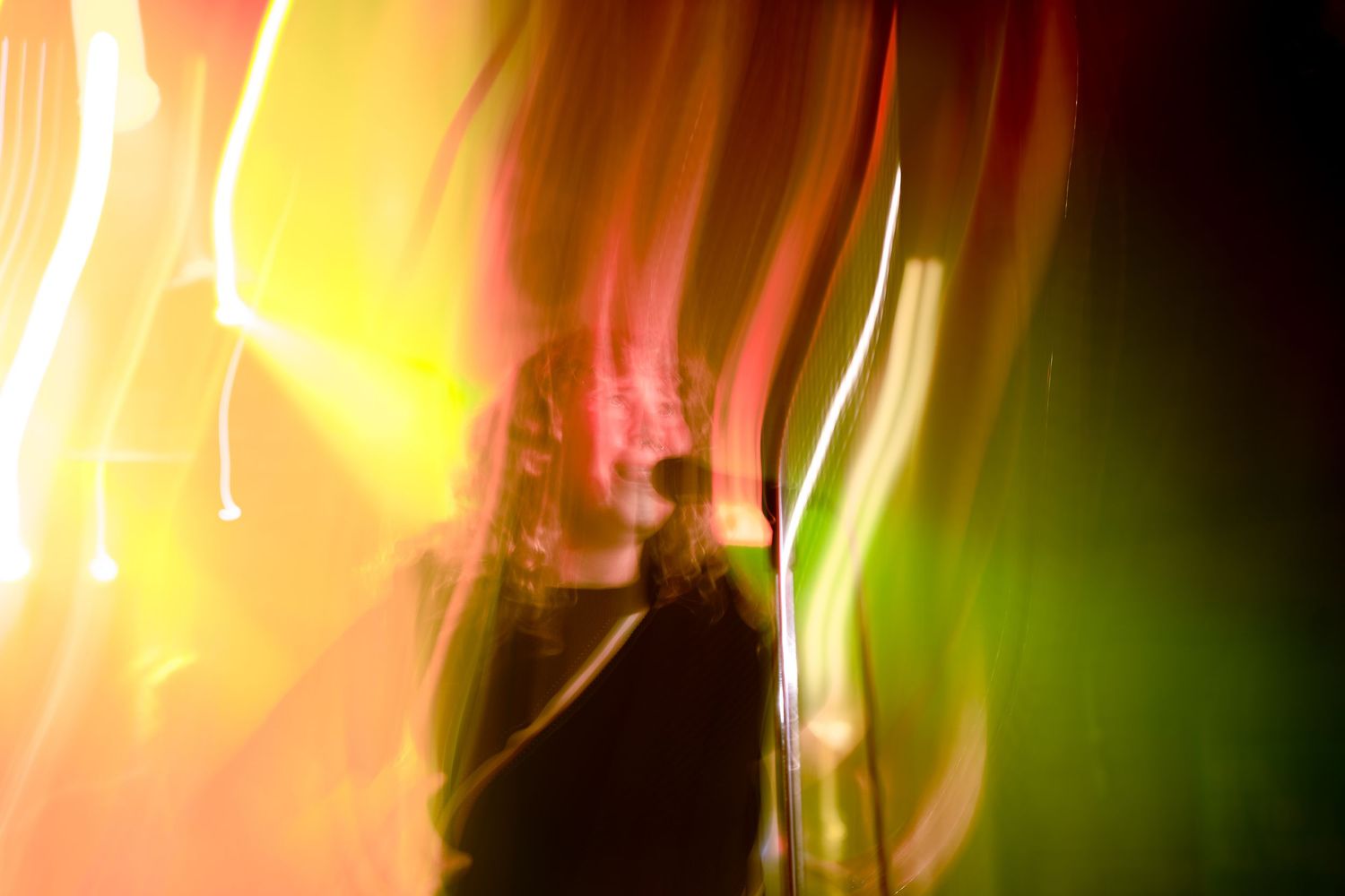Vibrant yellow and green light streaks creating an abstract pattern.