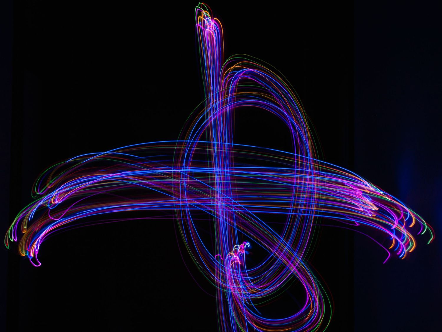 Abstract light trails create purple glowing patterns against a dark background.
