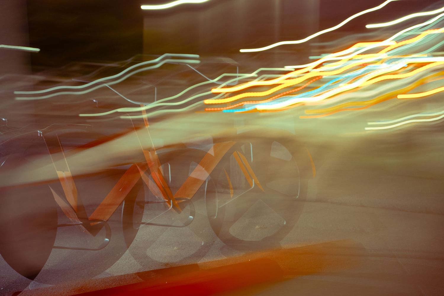 Long exposure light trails create yellow and white streaks in the darkness.