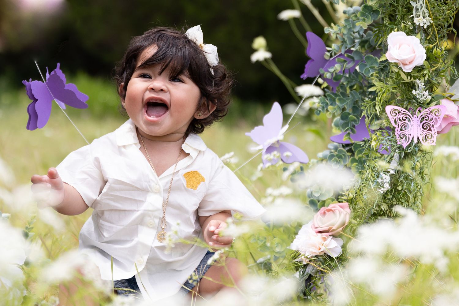 Garden photo session with purple butterflies and pink roses creating a magical atmosphere.