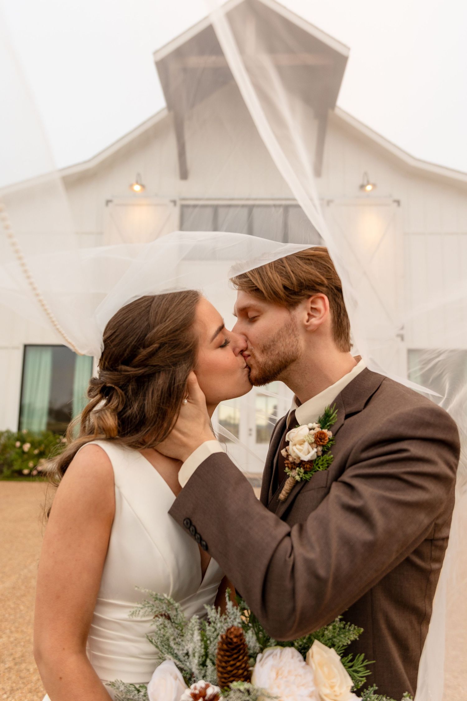 Romantic wedding portraits taken outside a white chapel building.